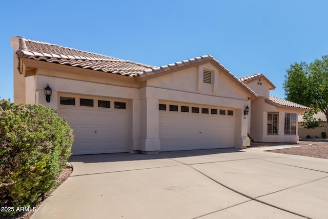 871 W Mesquite St, Gilbert, AZ 85233 - mediterranean / spanish-style home with an attached garage, stucco siding, and a tiled roof