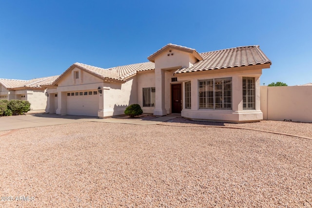 871 W Mesquite St, Gilbert, AZ 85233 - mediterranean / spanish house featuring stucco siding, a tiled roof, a garage, and concrete driveway