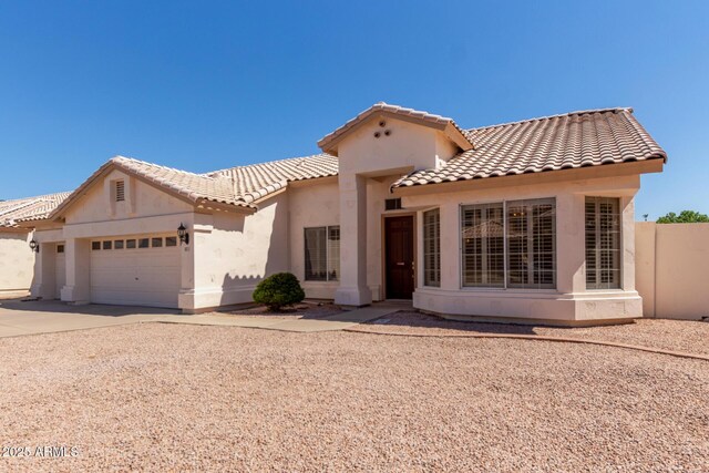 871 W Mesquite St, Gilbert, AZ 85233 - view of front facade featuring a tile roof, an attached garage, stucco siding, and concrete driveway