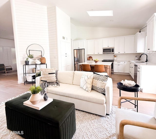 7297 E Black Rock Rd, Scottsdale, AZ 85255 - living area with lofted ceiling, light wood-style floors, and a skylight
