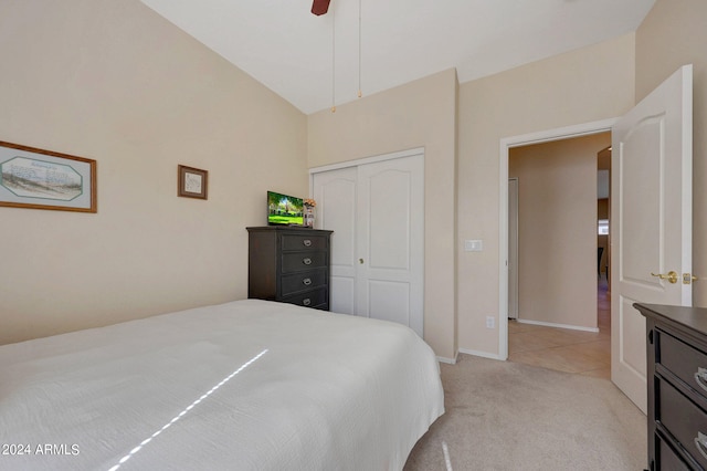 carpeted bedroom featuring vaulted ceiling, ceiling fan, and a closet