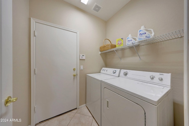 laundry room with separate washer and dryer and light tile patterned floors