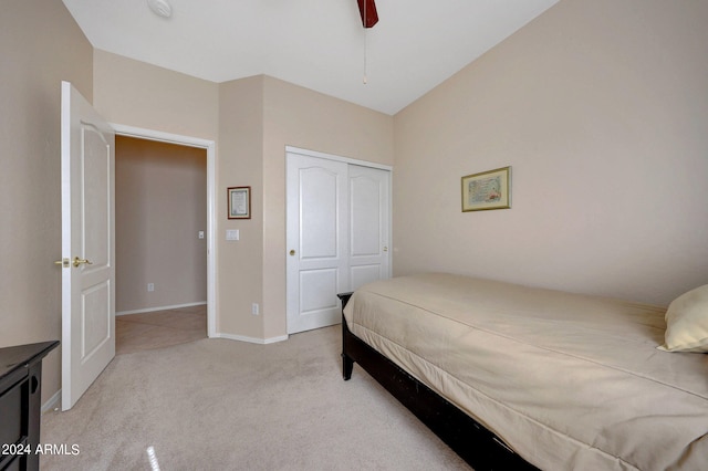 carpeted bedroom featuring a closet and ceiling fan