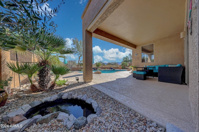 view of yard featuring an outdoor hangout area, a swimming pool with hot tub, and a patio area