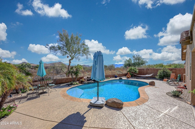 view of pool featuring a mountain view and a patio area