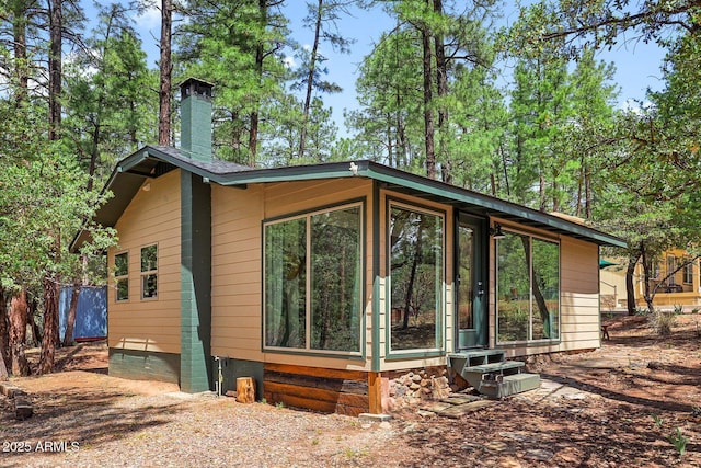 3674 N Navajo Dr, Pine, AZ 85544 - view of side of home with a chimney and entry steps