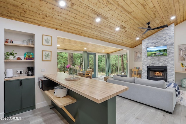3674 N Navajo Dr, Pine, AZ 85544 - kitchen with butcher block countertops, healthy amount of natural light, light wood-type flooring, wood ceiling, and a fireplace