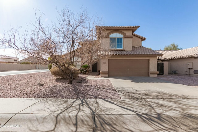 mediterranean / spanish home featuring driveway, a garage, a tiled roof, fence, and stucco siding