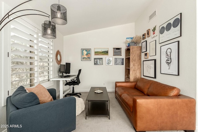 living area featuring lofted ceiling, baseboards, visible vents, and carpet