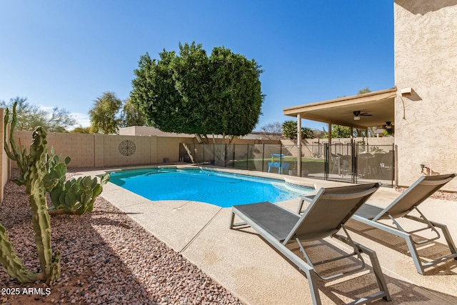 view of pool with a patio area, a fenced backyard, ceiling fan, and a fenced in pool