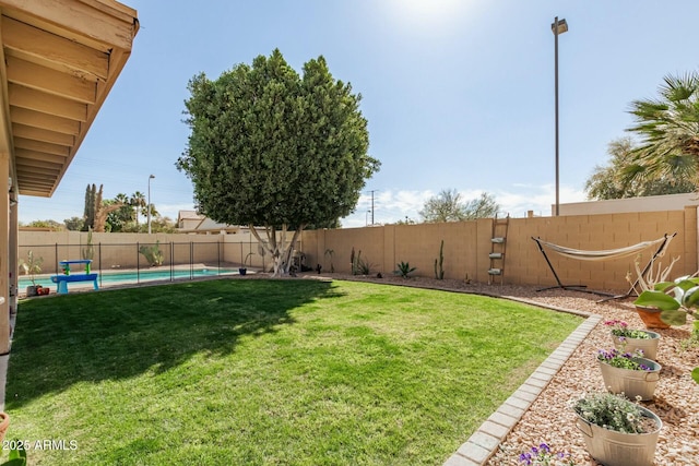 view of yard with a fenced in pool and a fenced backyard