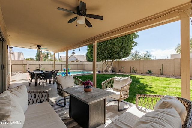 view of patio with a fenced in pool, a ceiling fan, a fenced backyard, outdoor lounge area, and outdoor dining space