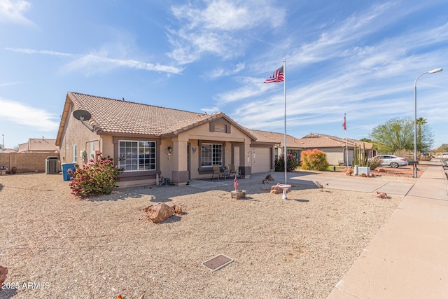 ranch-style house with central AC unit and a garage