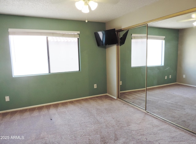 30 E Brown Rd Unit 2113, Mesa, AZ 85201 - unfurnished bedroom with carpet floors, a closet, a textured ceiling, and ceiling fan