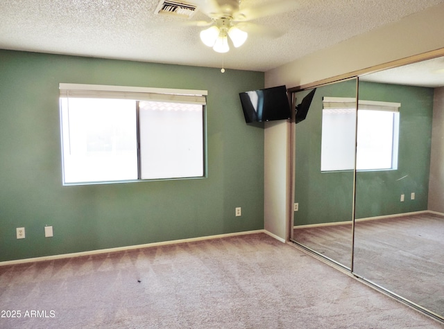 30 E Brown Rd Unit 2113, Mesa, AZ 85201 - unfurnished bedroom with carpet floors, a textured ceiling, a closet, and a ceiling fan