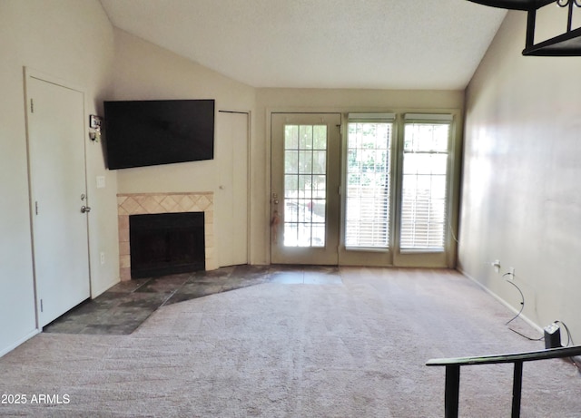 30 E Brown Rd Unit 2113, Mesa, AZ 85201 - unfurnished living room featuring lofted ceiling, carpet flooring, and a tiled fireplace