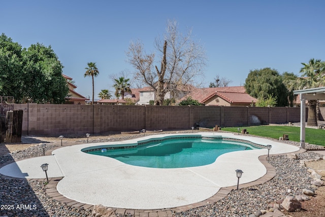 view of pool featuring a patio, a yard, a fenced backyard, and a fenced in pool