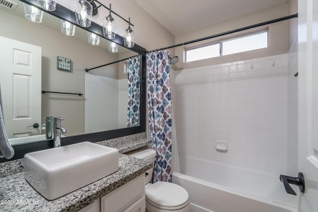 full bathroom featuring vanity, toilet, shower / bathtub combination with curtain, and visible vents