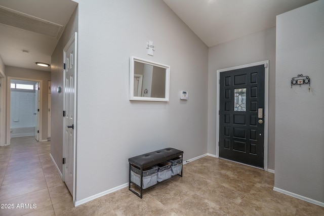 foyer featuring light tile patterned floors and baseboards