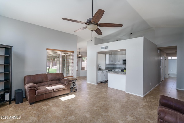 living room featuring high vaulted ceiling, a ceiling fan, visible vents, and baseboards