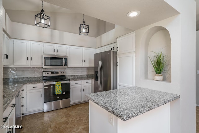 kitchen with light stone counters, backsplash, appliances with stainless steel finishes, and white cabinetry