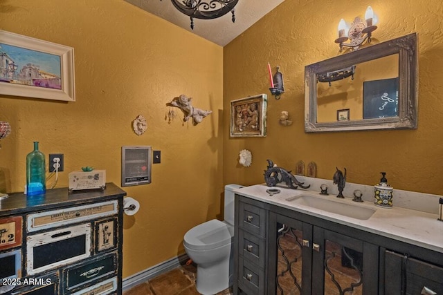 14 Black Knob Vw, Bisbee, AZ 85603 - bathroom with toilet, vanity, tile patterned floors, a textured wall, and baseboards