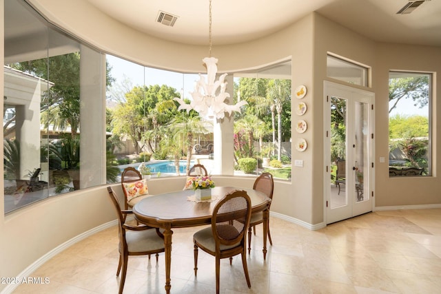 tiled dining space featuring visible vents, a chandelier, and baseboards