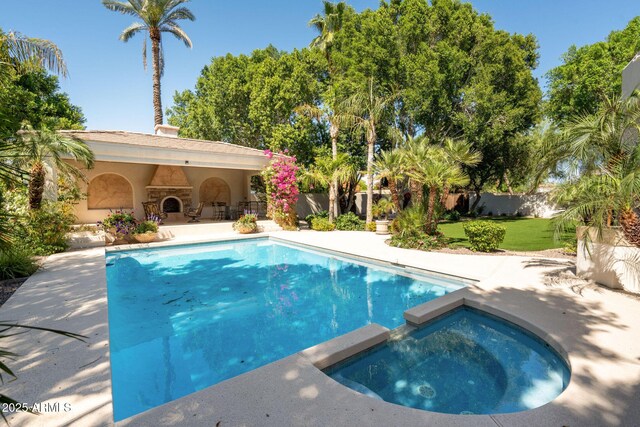 view of swimming pool featuring a patio, fence, a yard, and a pool with connected hot tub