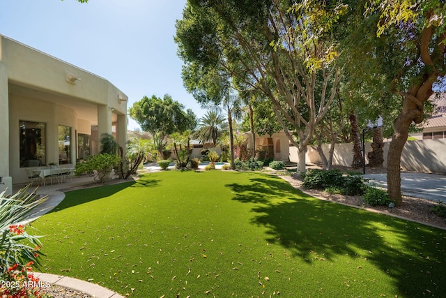 view of yard with fence and a patio