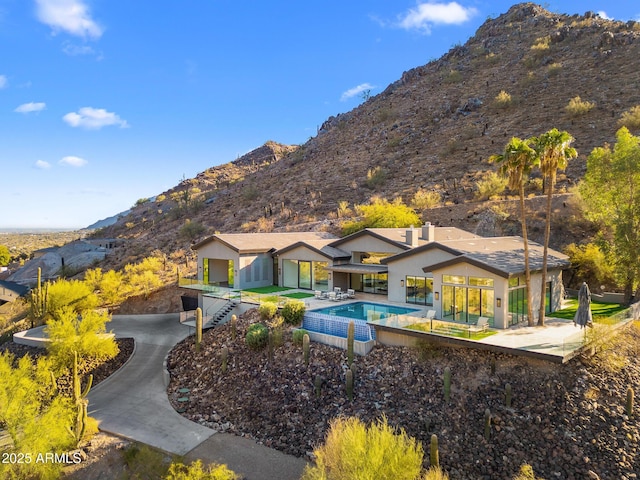 view of pool with a patio and a mountain view