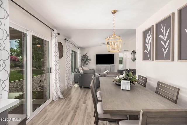 9265 E Kalil Dr, Scottsdale, AZ 85260 - dining space with wood finished floors, a chandelier, and vaulted ceiling