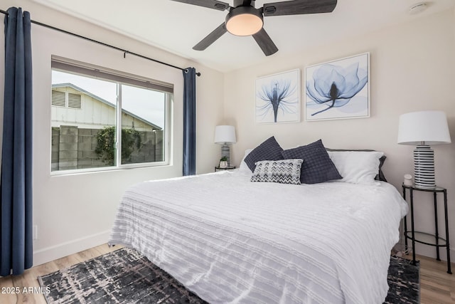 9265 E Kalil Dr, Scottsdale, AZ 85260 - bedroom with wood finished floors, baseboards, and a ceiling fan