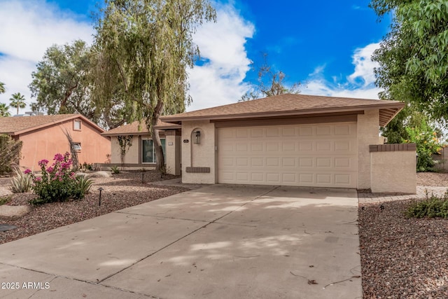 9265 E Kalil Dr, Scottsdale, AZ 85260 - view of front facade featuring stucco siding, driveway, and a garage