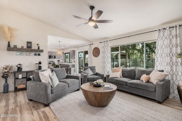 9265 E Kalil Dr, Scottsdale, AZ 85260 - living area featuring vaulted ceiling, light wood-style floors, and ceiling fan