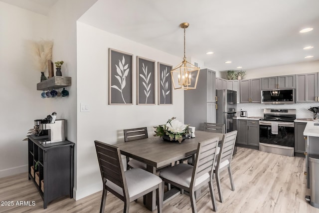9265 E Kalil Dr, Scottsdale, AZ 85260 - dining space featuring light wood finished floors, a chandelier, recessed lighting, and baseboards