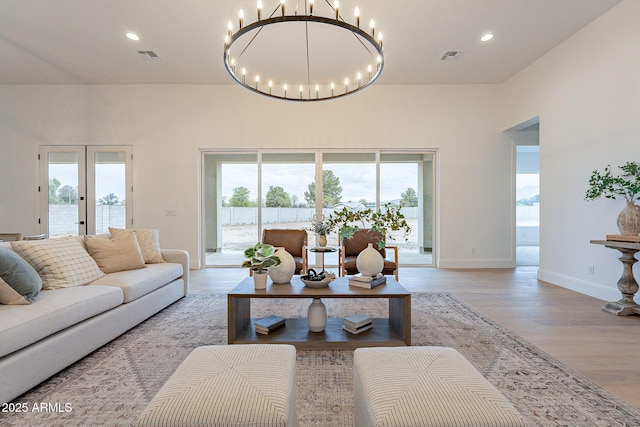 living room with visible vents, recessed lighting, and light wood-type flooring