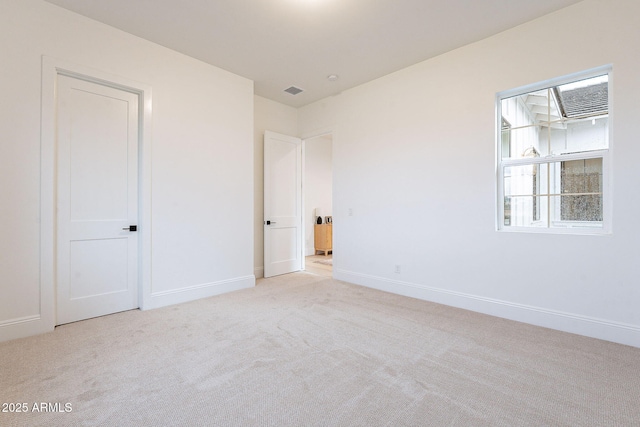 unfurnished bedroom with visible vents, carpet, and baseboards