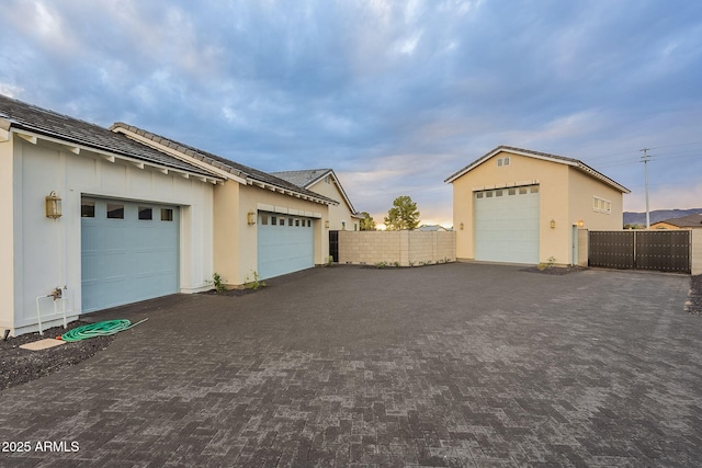 garage at dusk with fence