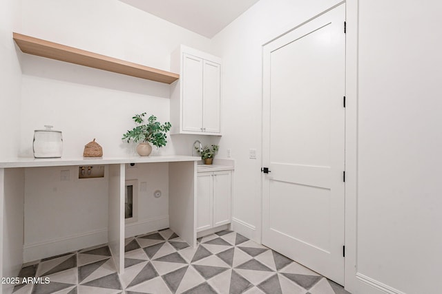 washroom with cabinet space, light floors, washer hookup, and hookup for an electric dryer