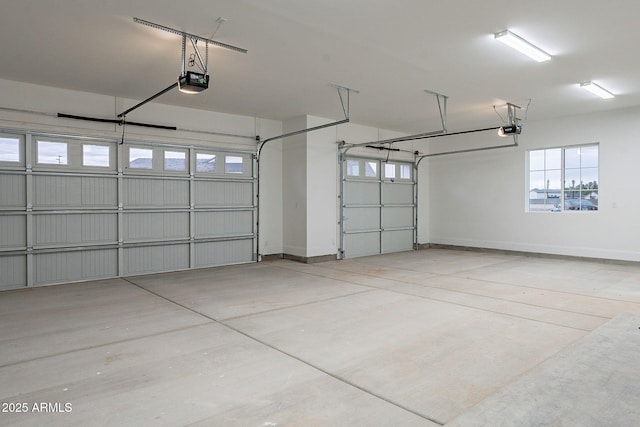 garage with a garage door opener and baseboards