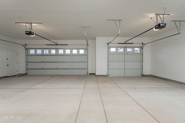 garage with a garage door opener and baseboards