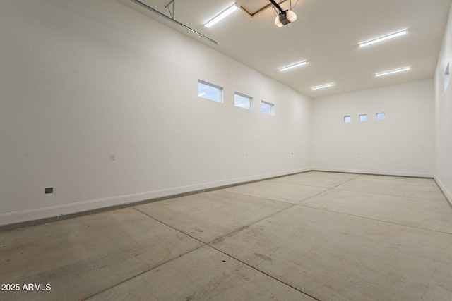 garage with a garage door opener and baseboards