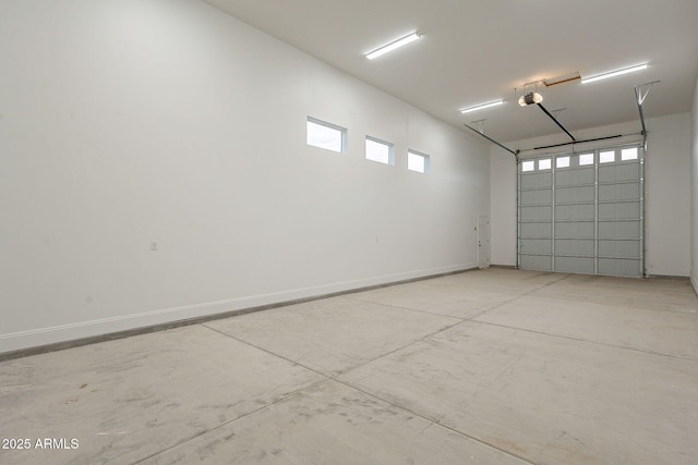 garage with baseboards and a garage door opener