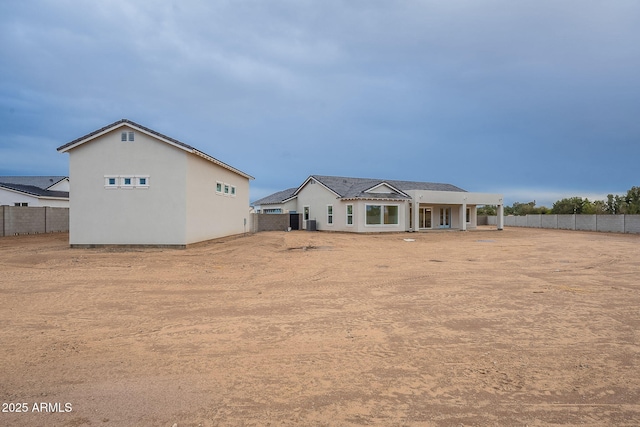 rear view of property with fence