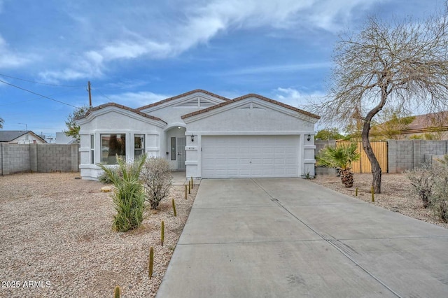 ranch-style house with fence, a tile roof, concrete driveway, stucco siding, and a garage