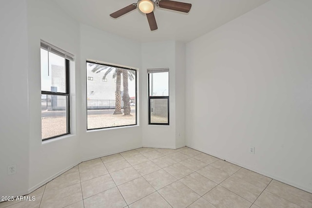 unfurnished room with ceiling fan and light tile patterned flooring