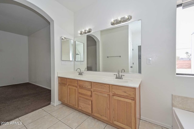 bathroom with tile patterned flooring, double vanity, and a sink