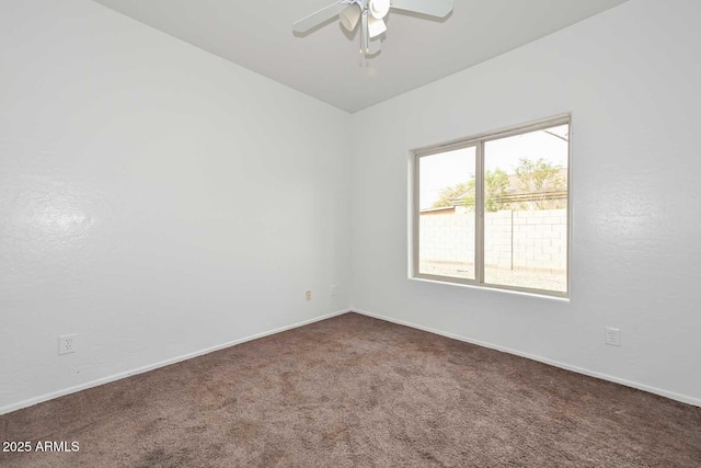 empty room featuring baseboards, carpet floors, and ceiling fan