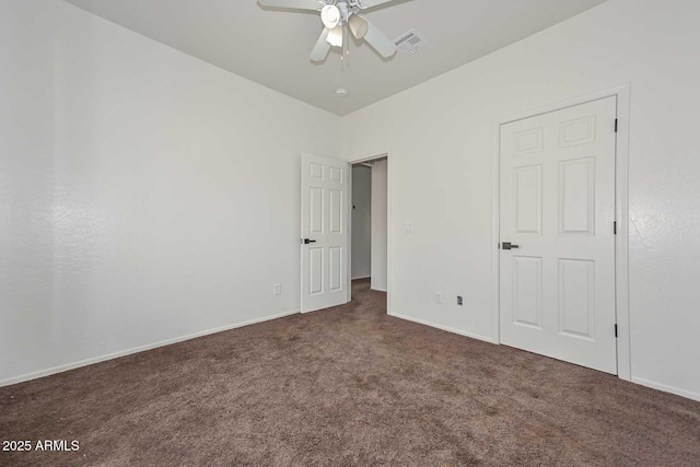 unfurnished bedroom with visible vents, carpet floors, baseboards, and a ceiling fan