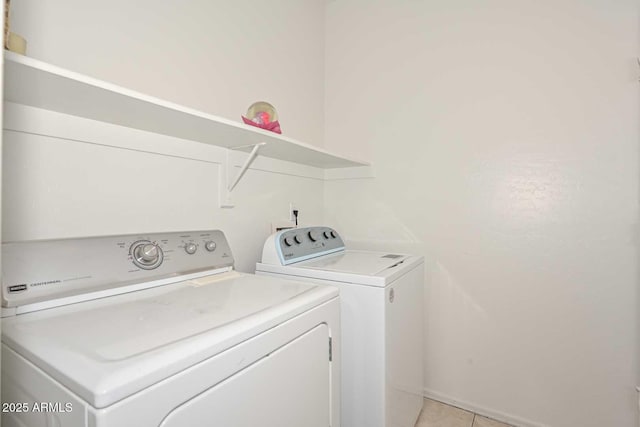 washroom featuring light tile patterned floors, independent washer and dryer, and laundry area